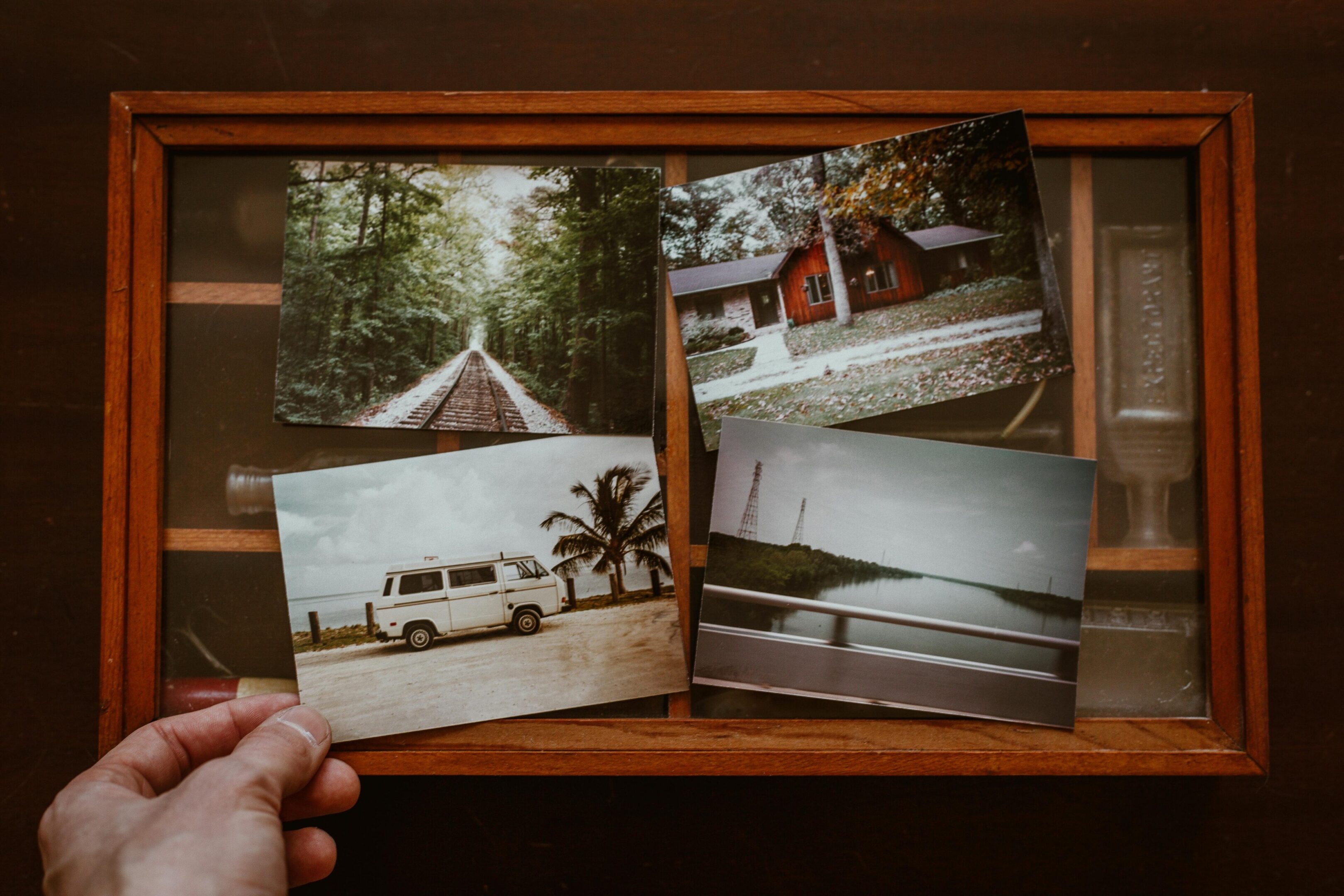 Four vintage-style travel photos laid out on a wooden surface.